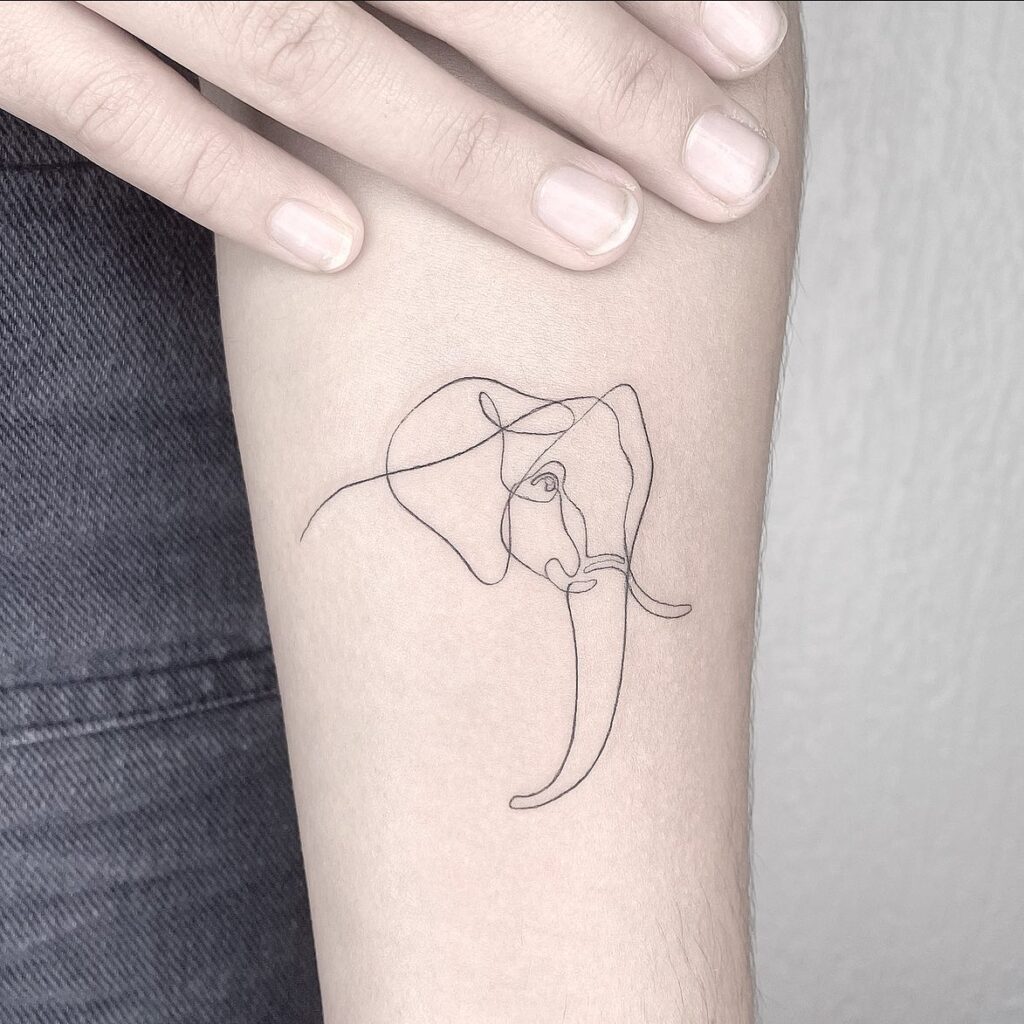 Fineline outline elephant head side view tattoo on forearm: thin line elegance