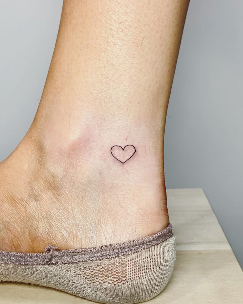 Fineline outline love heart near the ankle subtle tattoo inspiration