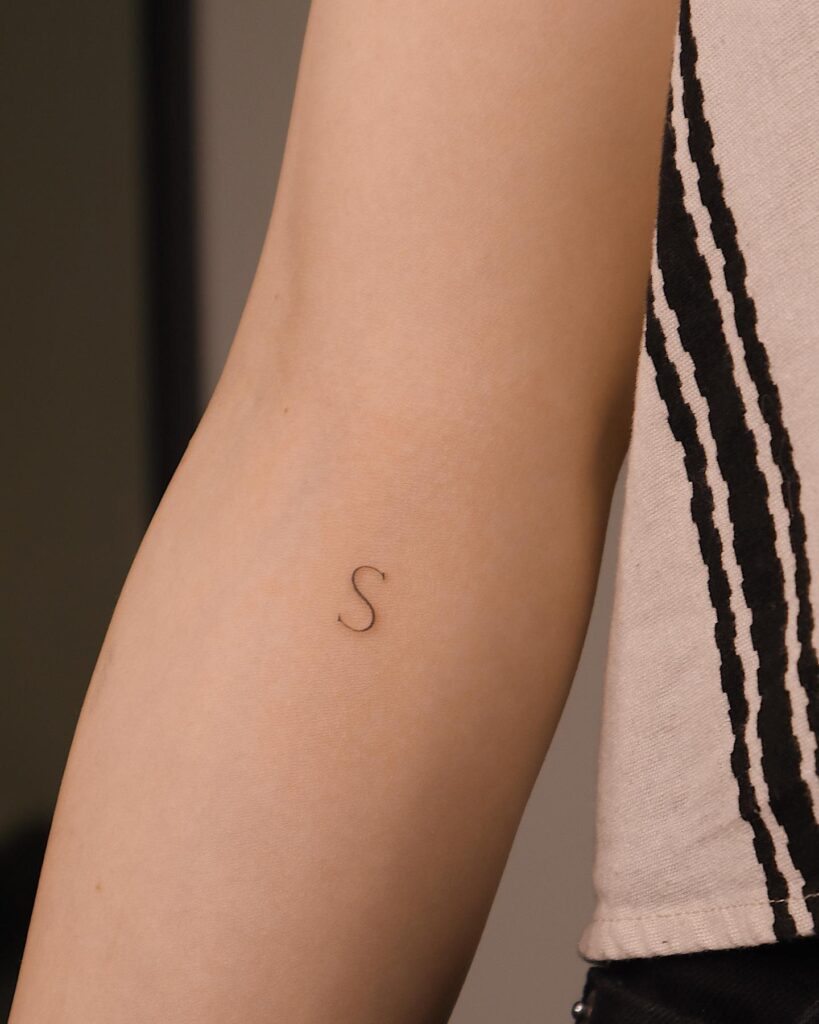 Fineline 'S' Letter Tattoo Below the Inner Elbow: Whisper-Thin 'S'