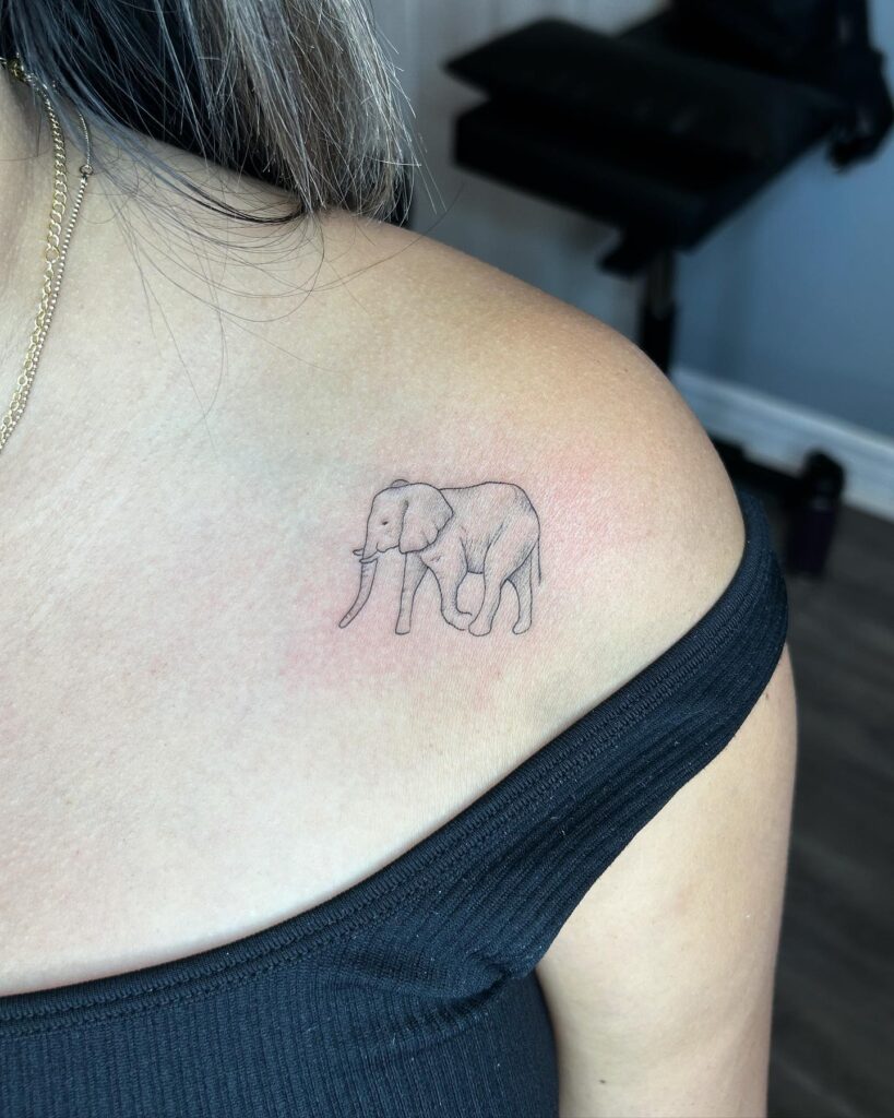 Fineline side view elephant tattoo for animal lovers: elegant shoulder companion