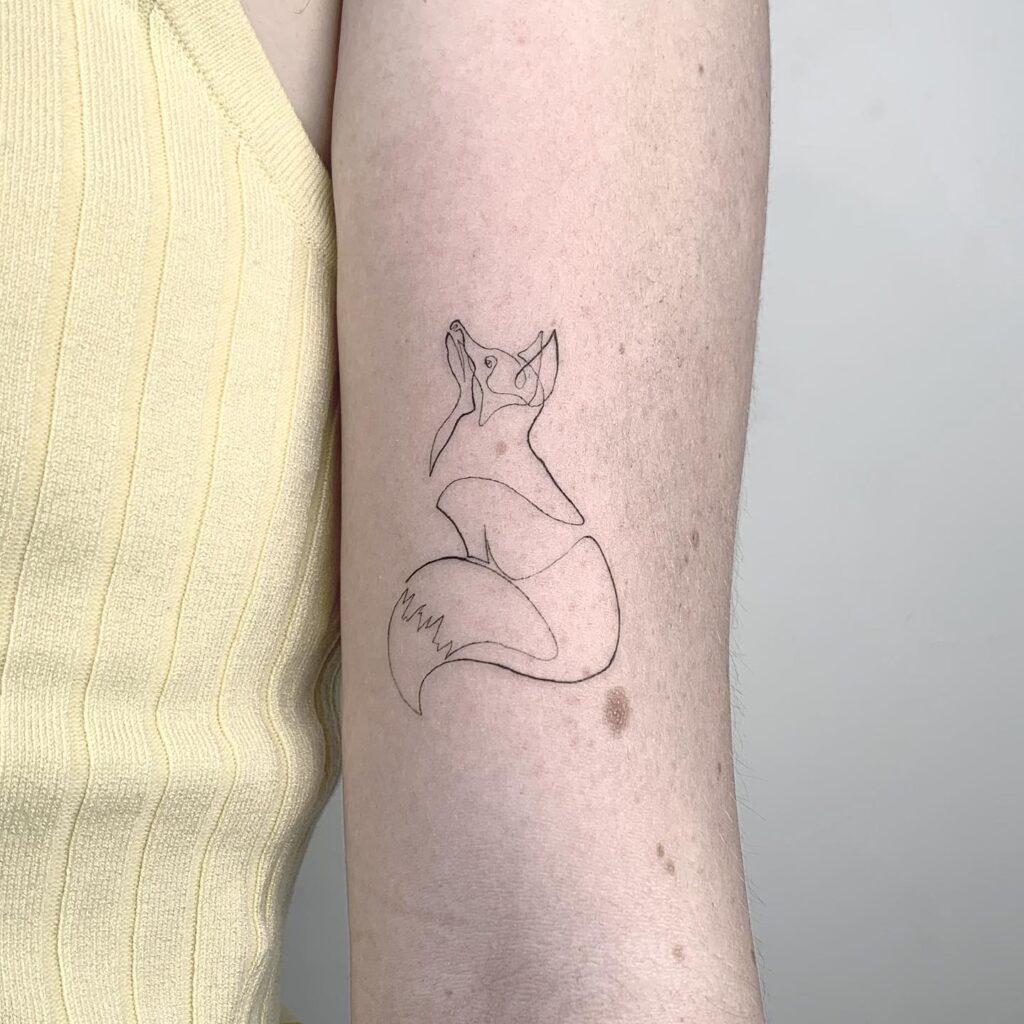 Fineline Single Line Sitting Fox Tattoo Above the Elbow with Head Raised: Fine Fox Lines