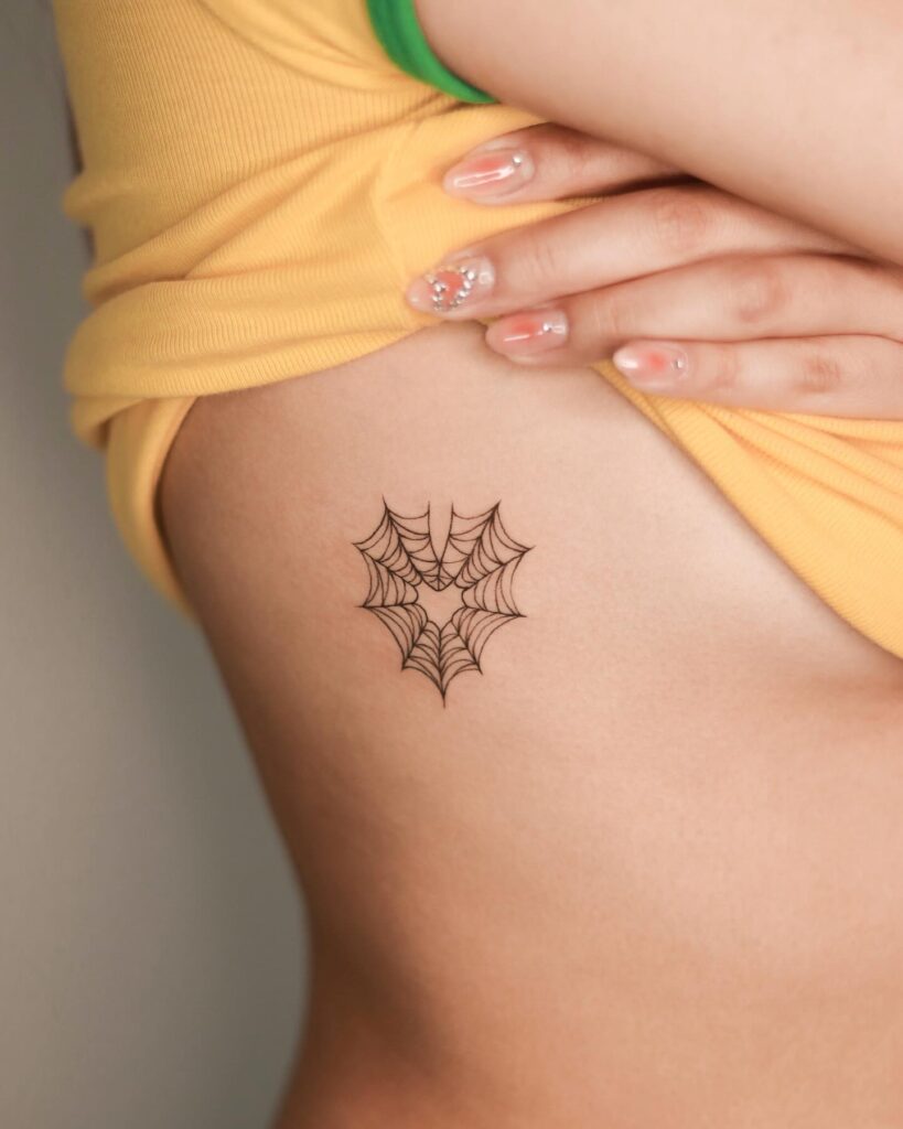 Fineline Spider in Heart Shape Tattoo on the Rib, a Feminine Delicacy: Arachnid Heartbeat