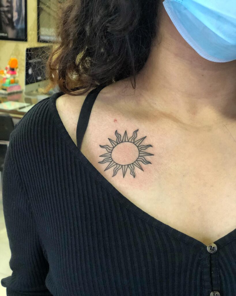 Fineline sun tattoo on collarbone, a minimalistic and chic accent solar elegance