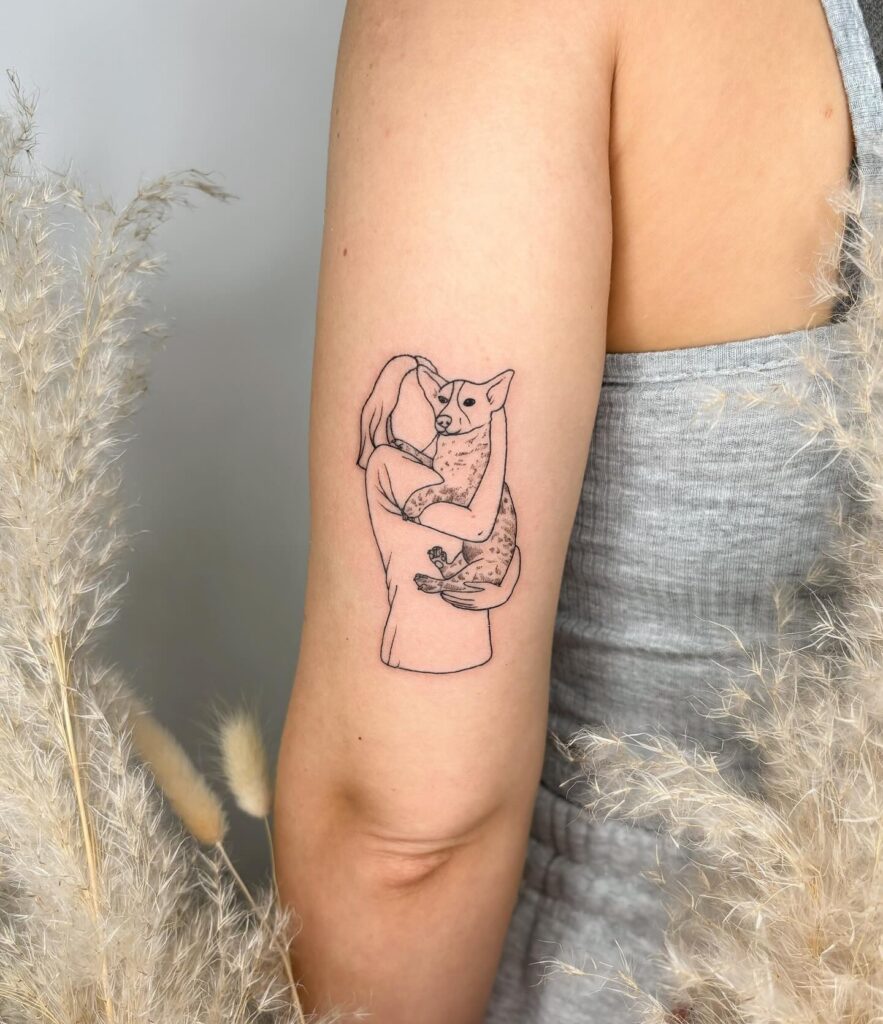 Fineline Tattoo of a Young Girl Hugging and Kissing a Dog Above the Back of the Elbow: Eternal Bond