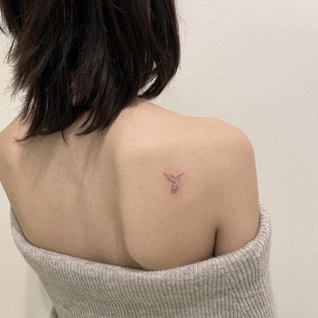 Fineline tiny hummingbird shoulder tattoo: graceful and intricate detail