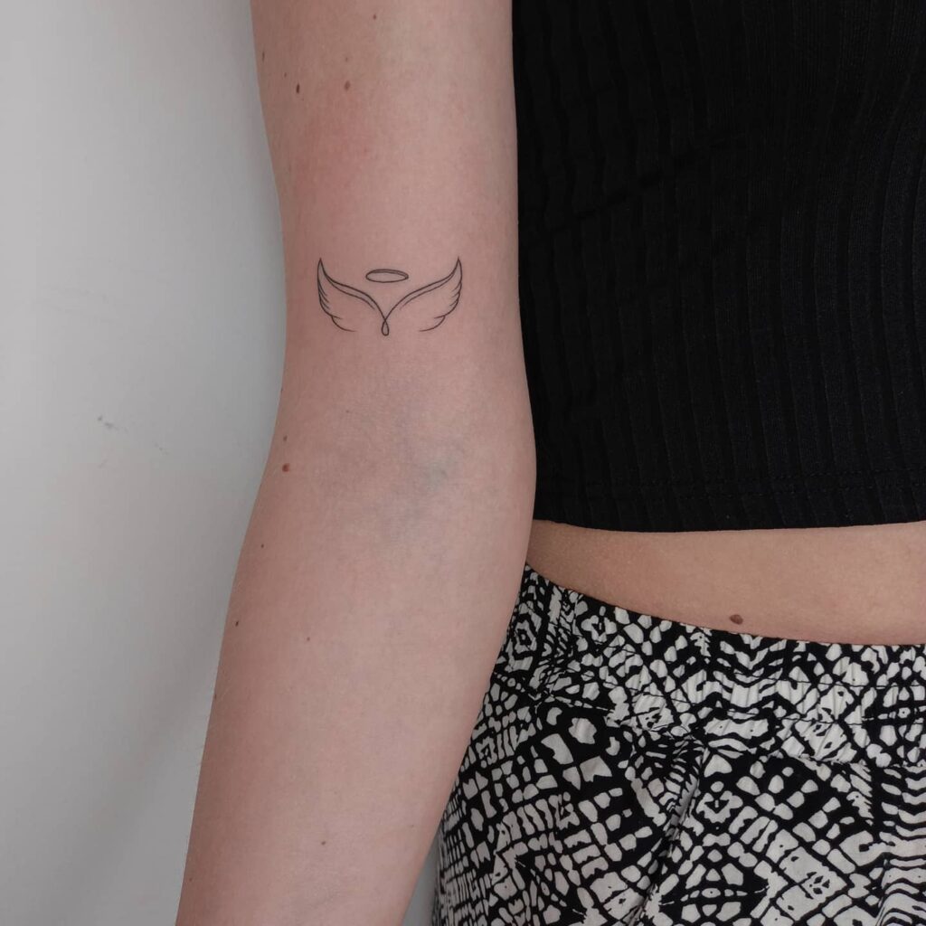 Fineline Wings Tattoo Above the Elbow for a Clean Aesthetic: Elegant Rise
