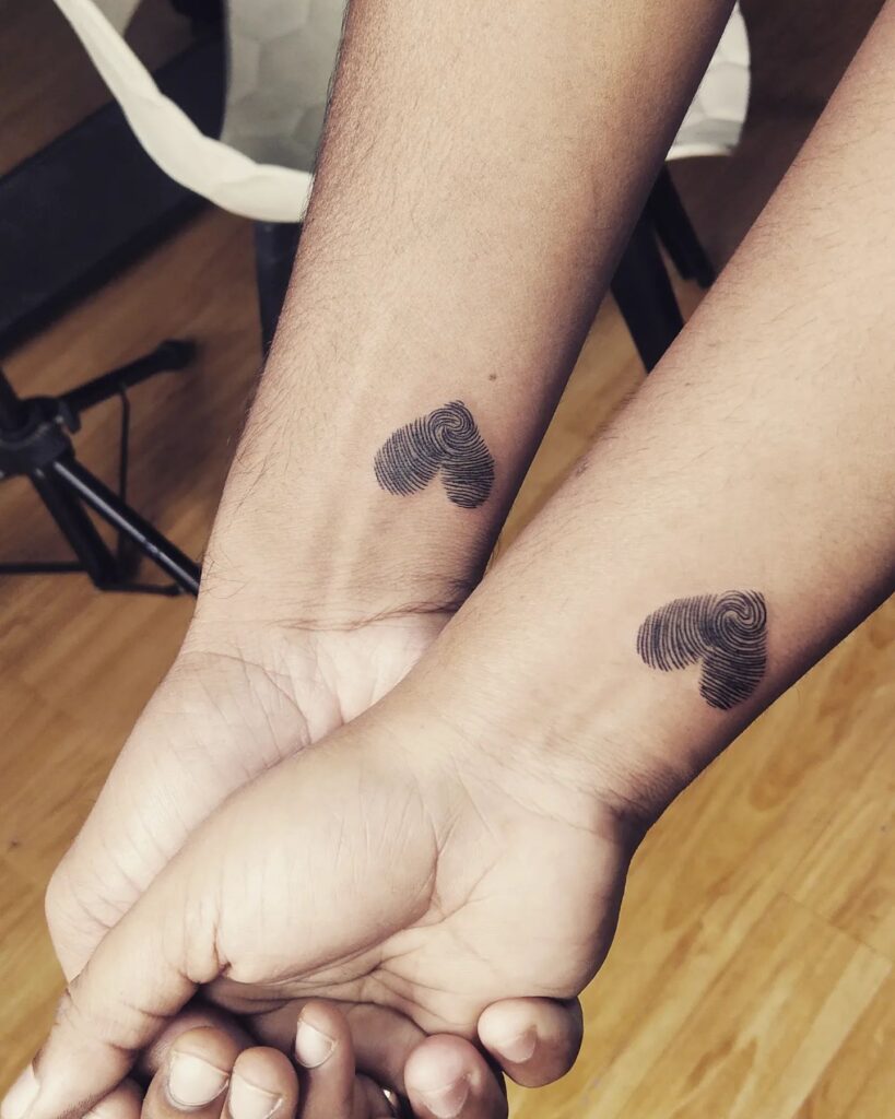 Fingerprint hearts couple matching wrist tattoos
