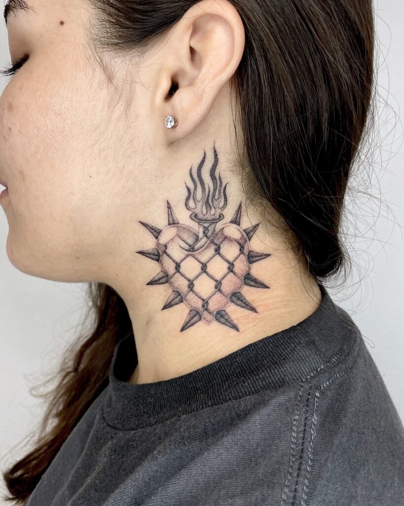 Flaming Heart and Chain Link Tattoo Symbolizing Passion and Resilience