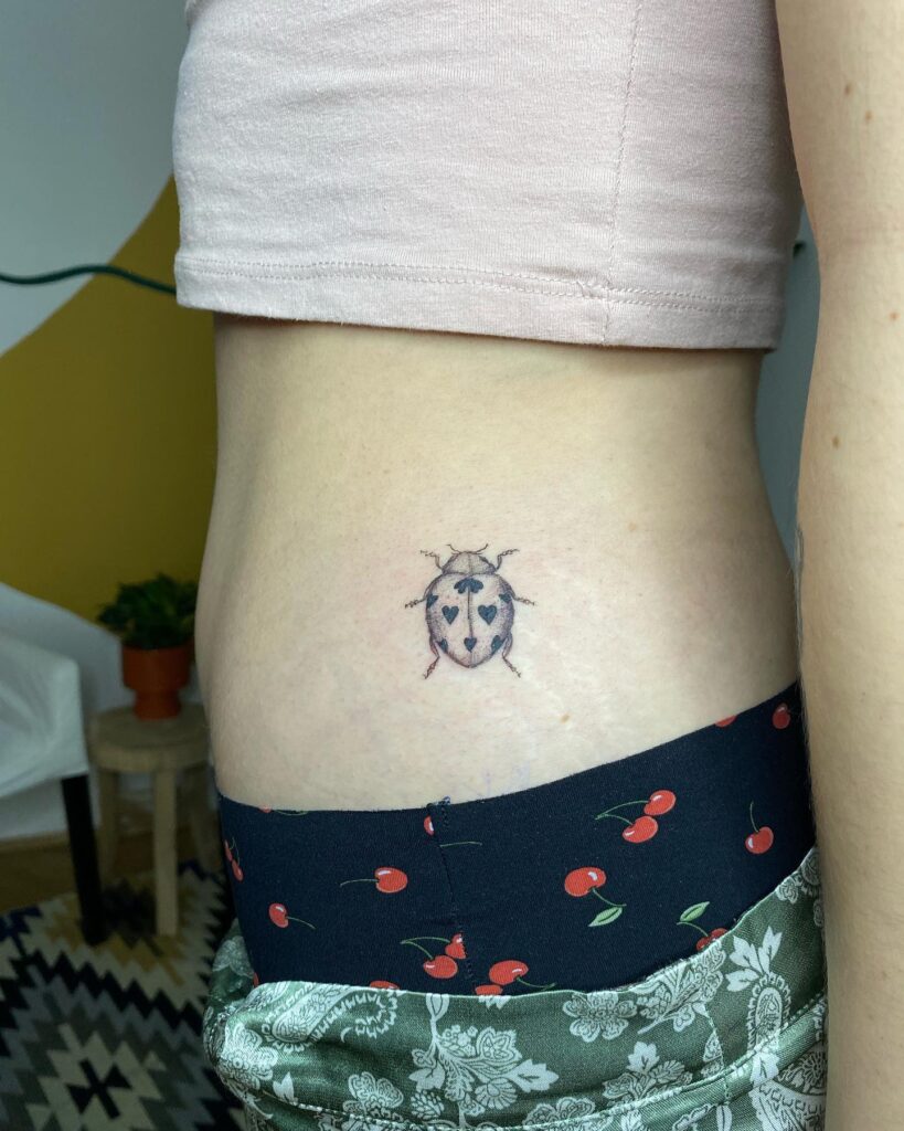 Flirty and stylish waist small side belly ladybug tattoo for women