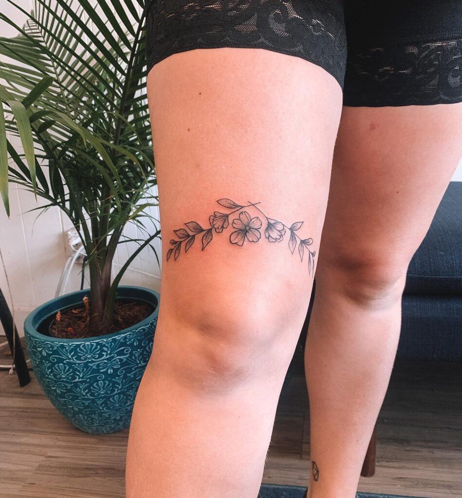 Floral flourish above the knee tattoo beauty