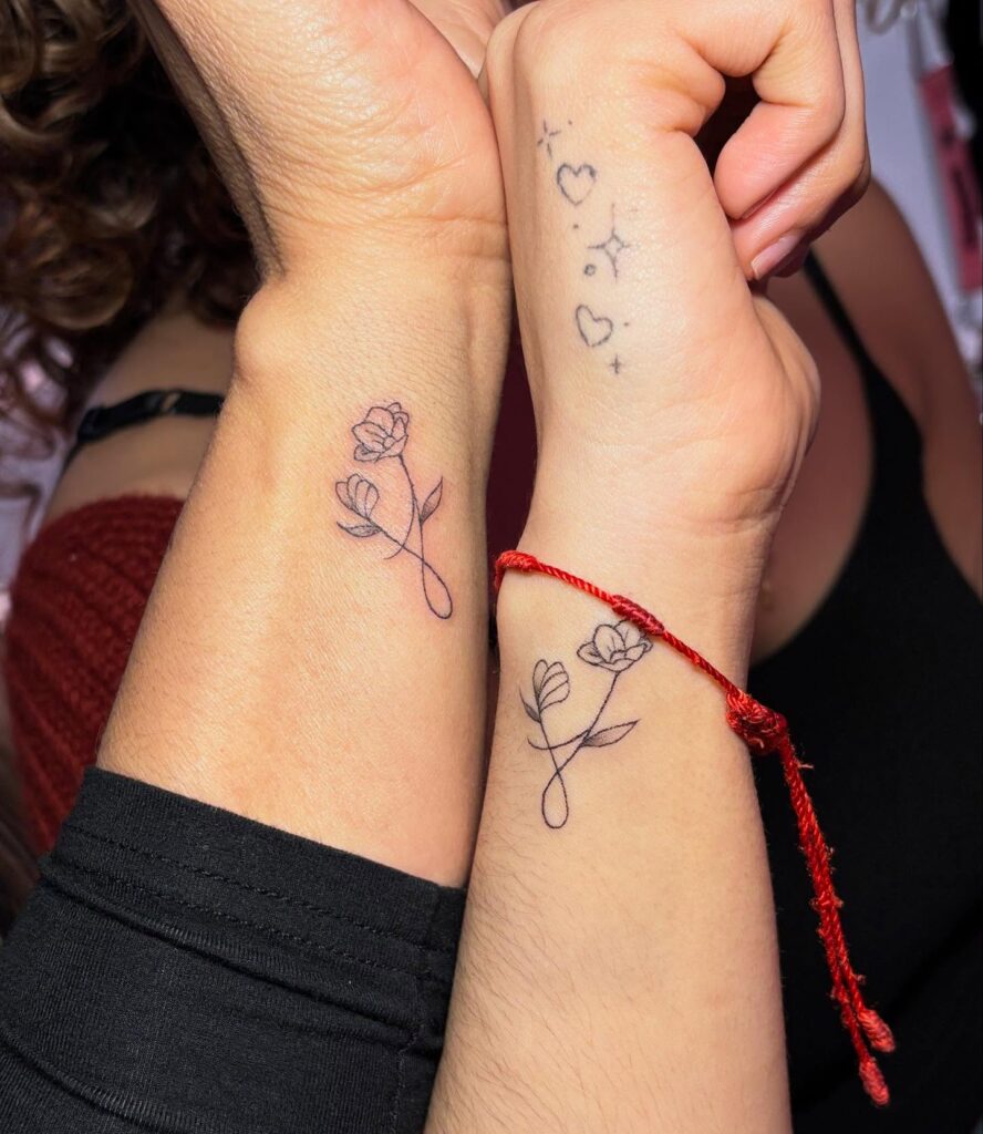 Floral infinity tattoos for mother and daughter that symbolize eternal love and growth