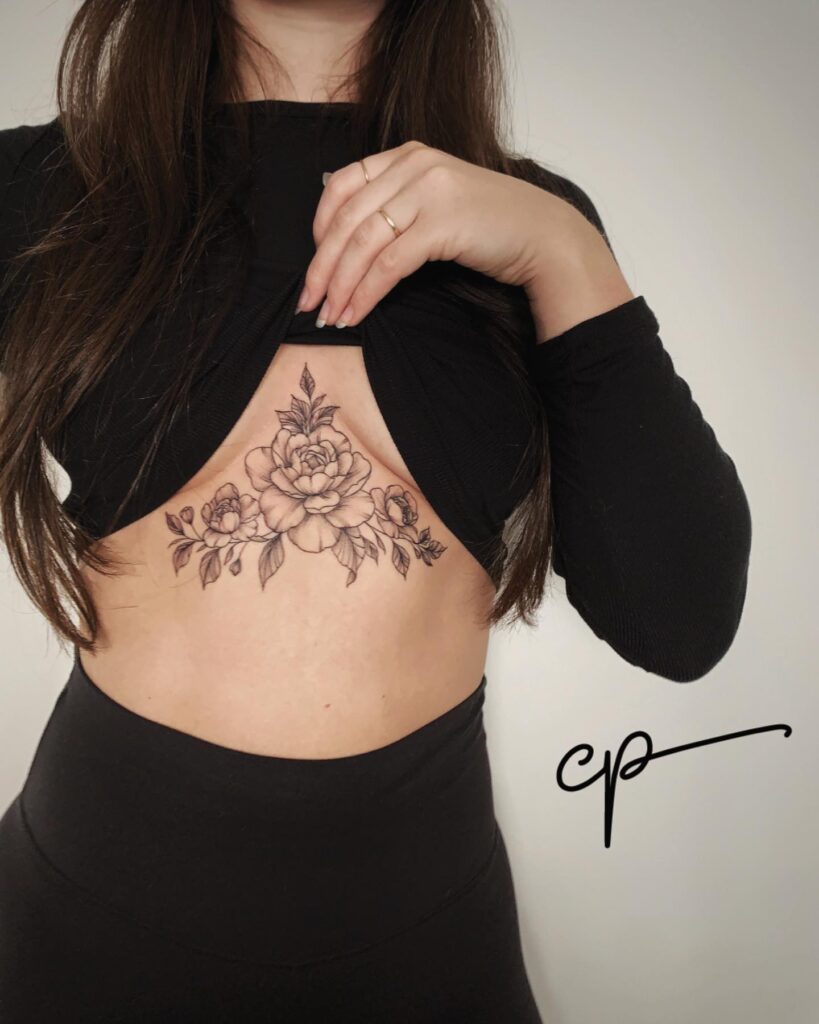 Floral sternum tattoo with shaded peony and rose for beauty and strength