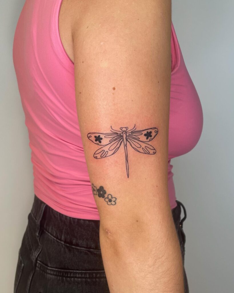 Floral Wing Dragonfly Tattoo with Bold Linework on Upper Arm