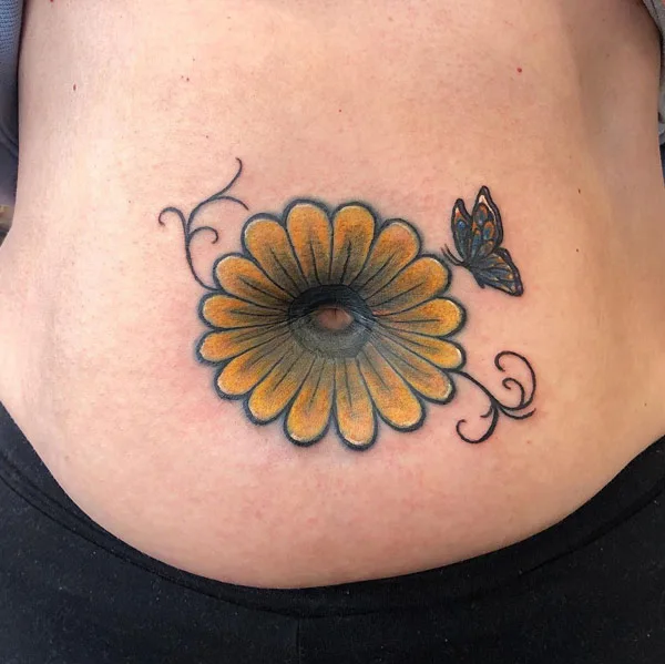 Flower belly button tattoo