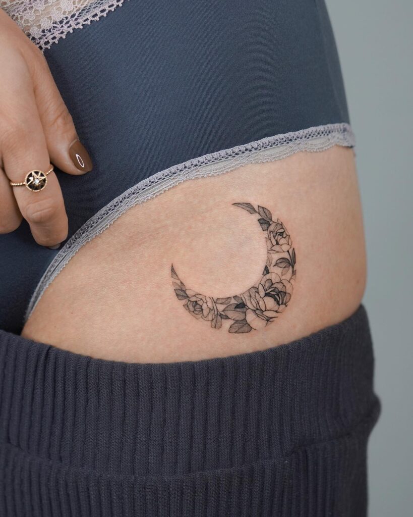 Flowers Moon Tattoo on the Hip, Merging Nature's Beauty with Lunar Magic: Celestial Bloom