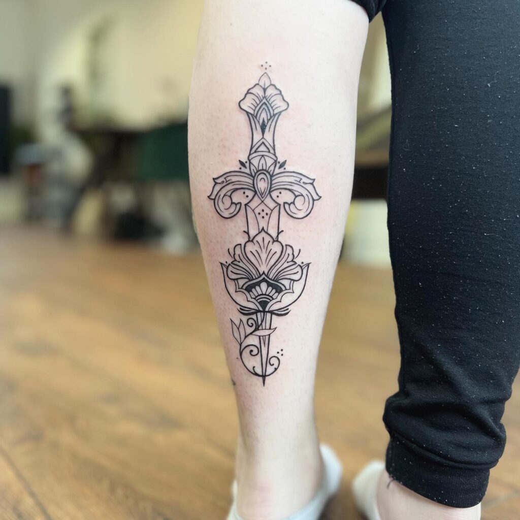Flowery dagger leg tattoo design for girls & women