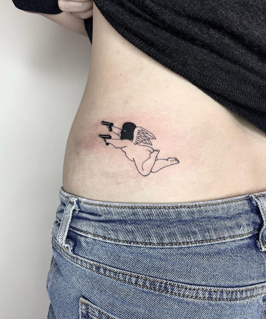 Flying angel double gun tattoo with meaning Flying angel double gun tattoo with meaning
