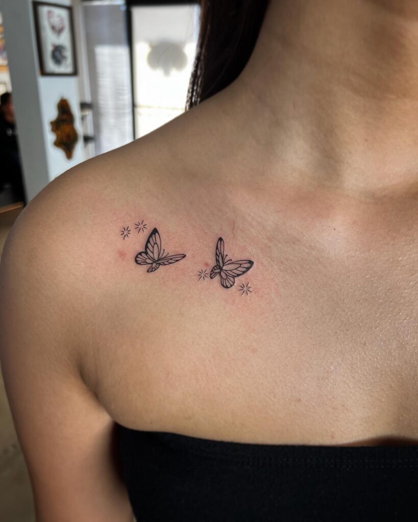 Flying butterflies and sparkle tattoo on the collarbone, small butterflies surrounded by stars fluttering radiance