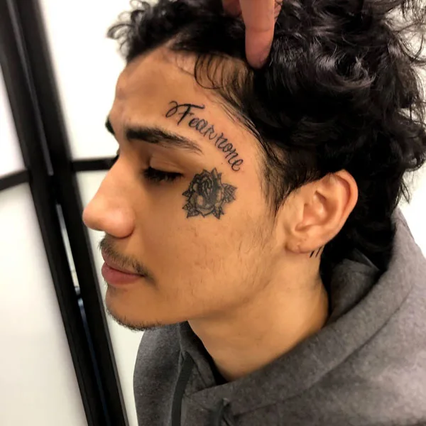 Forehead fear none tattoo