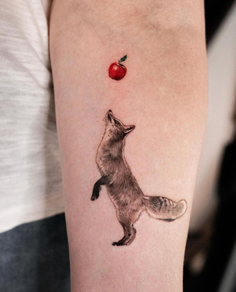 Fox Jumping for an Apple Tattoo on the Arm, Red Color Apple with Black and Grey Fox: Apple Leap