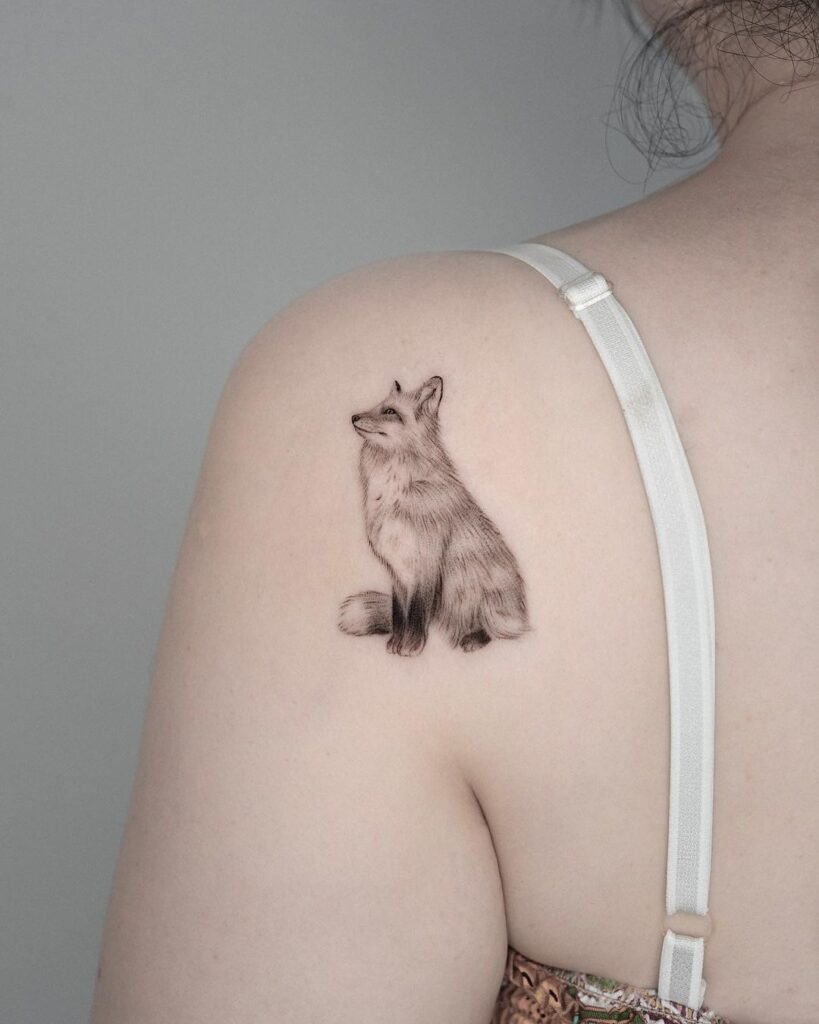 Fox tattoo behind the shoulder a cute and curious observer