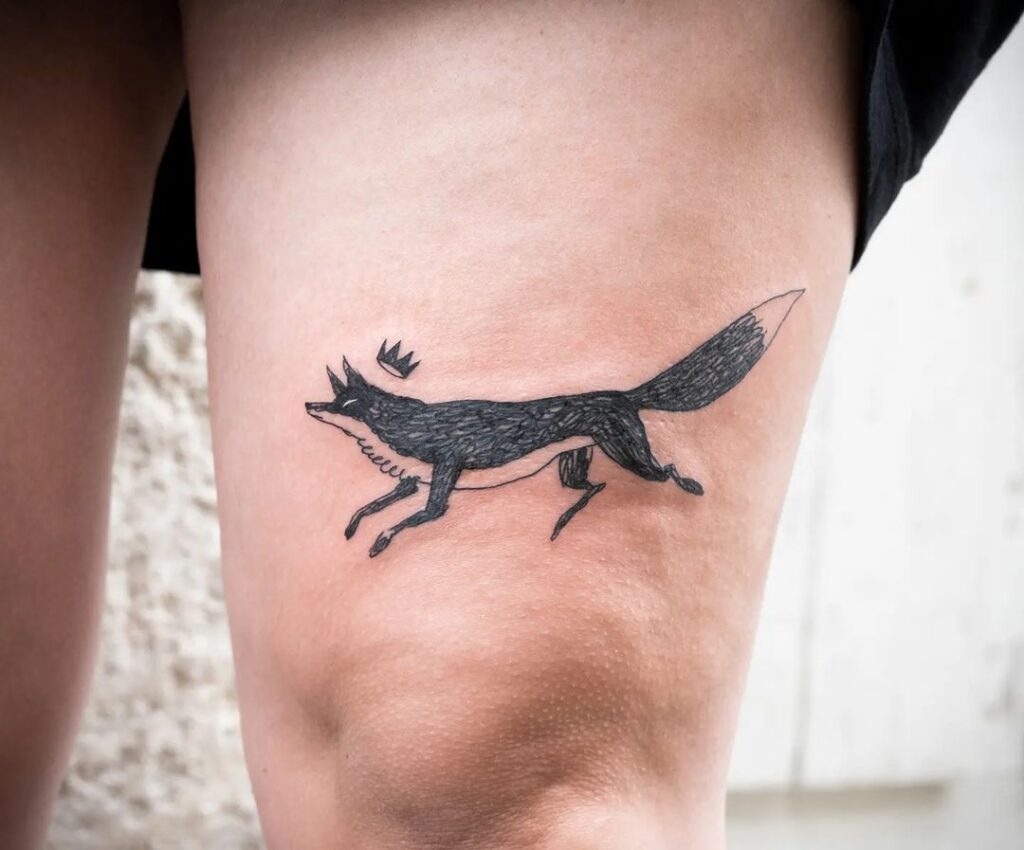 Fox with crown above the knee a regal symbolic tattoo