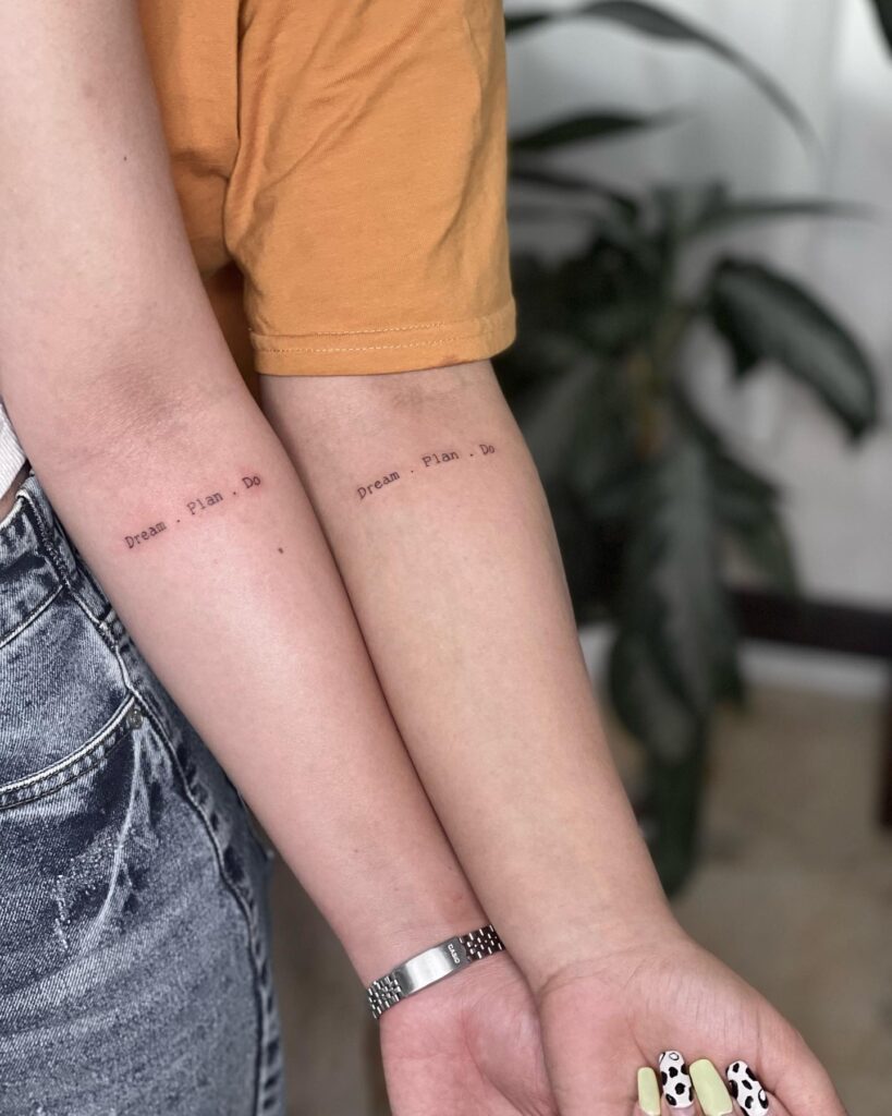 Friends Matching Text Tattoo on the Forearm, a Shared Motto: Dream, Plan, Do
