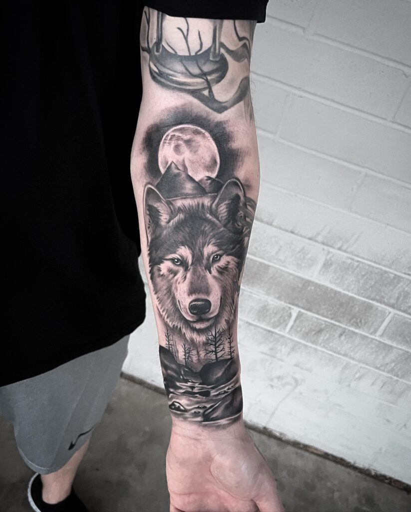 Full moon wolf mountain tattoo for men howling at nature's beauty