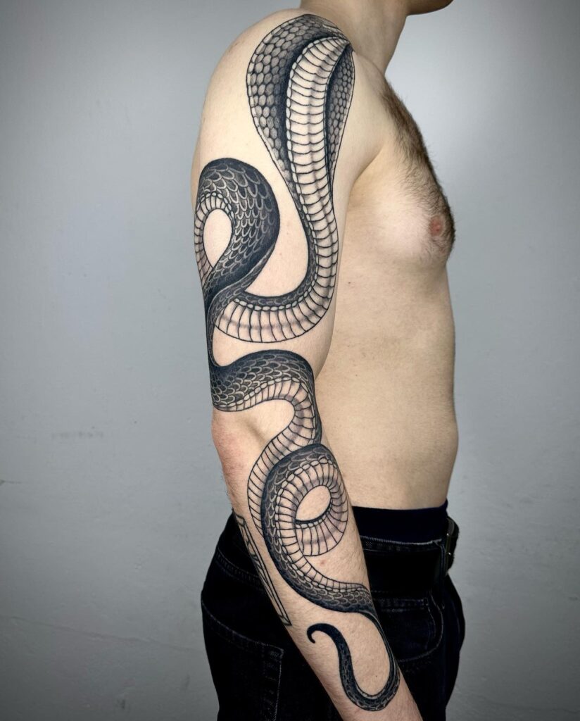 Full sleeve cobra tattoo for men, showcasing the cobra in all its glory: healed majesty