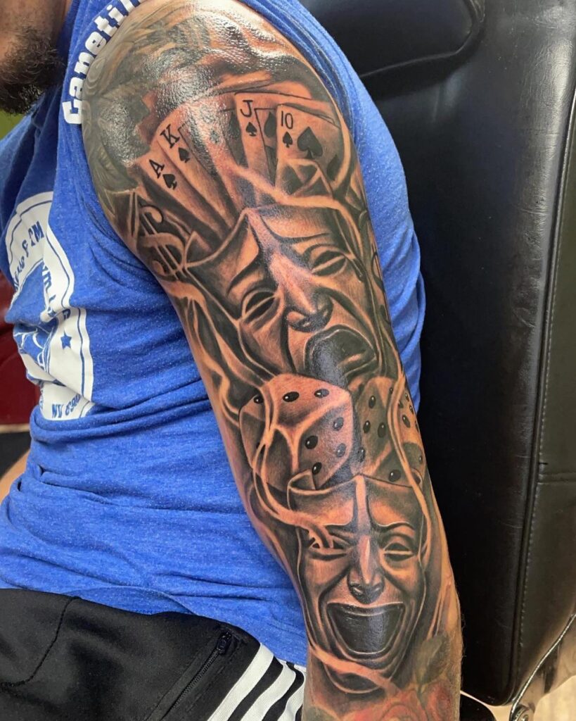 Full sleeve story laugh now cry later tattoo with dice and cards 