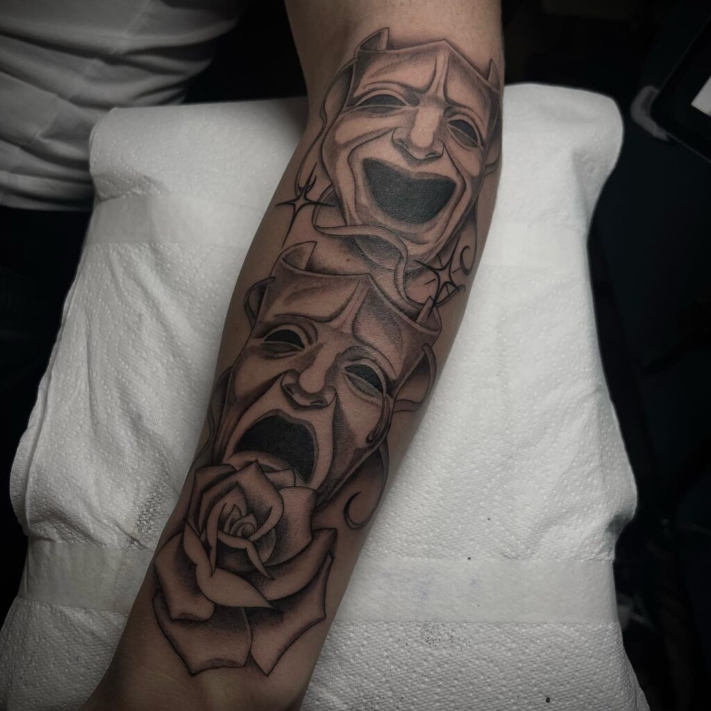 Fully Covered Forearm Laugh Now Cry Later Mask with Rose Tattoo: Black and Grey Mastery