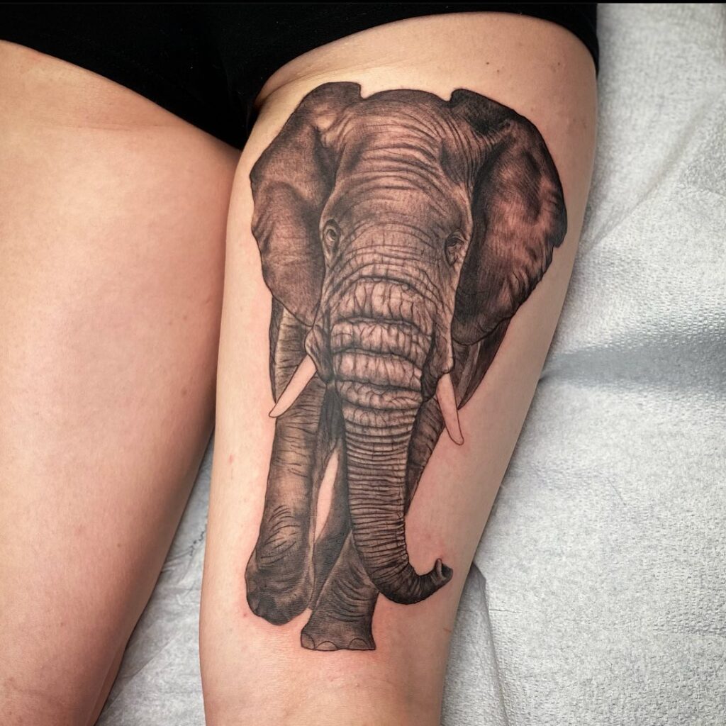 Fully covered front view thigh tattoo for women: indian elephant splendor