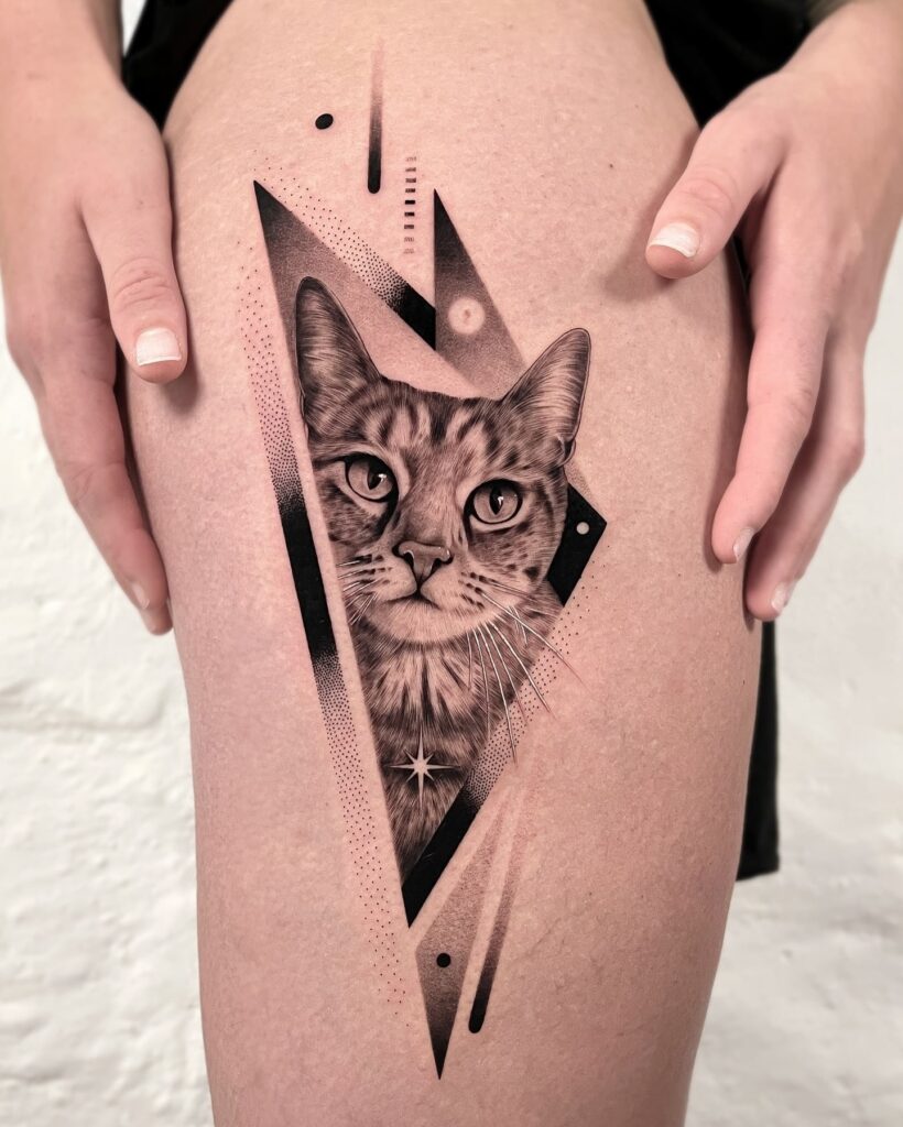 Geometric cat tattoo on thigh with cosmic and dotwork elements