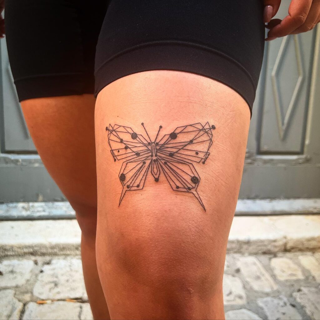 Geometric elegance minimalist butterfly tattoo on thigh