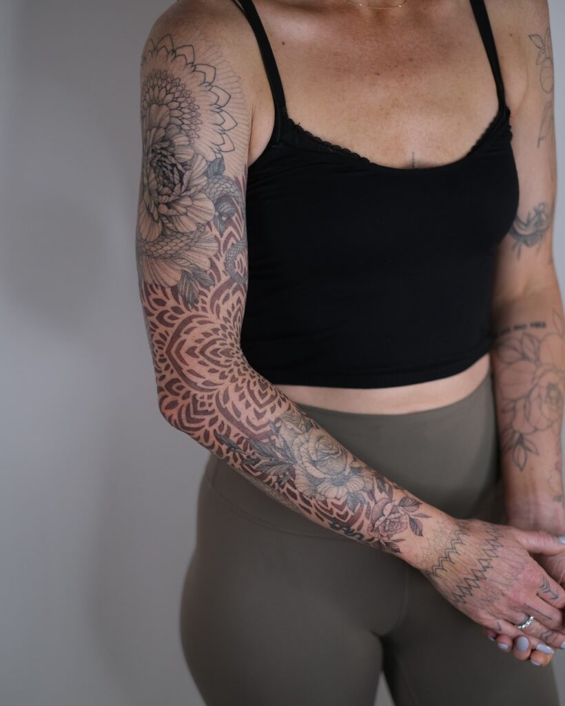 Geometric floral tattoo sleeve design with chrysanthemums and mandala patterns