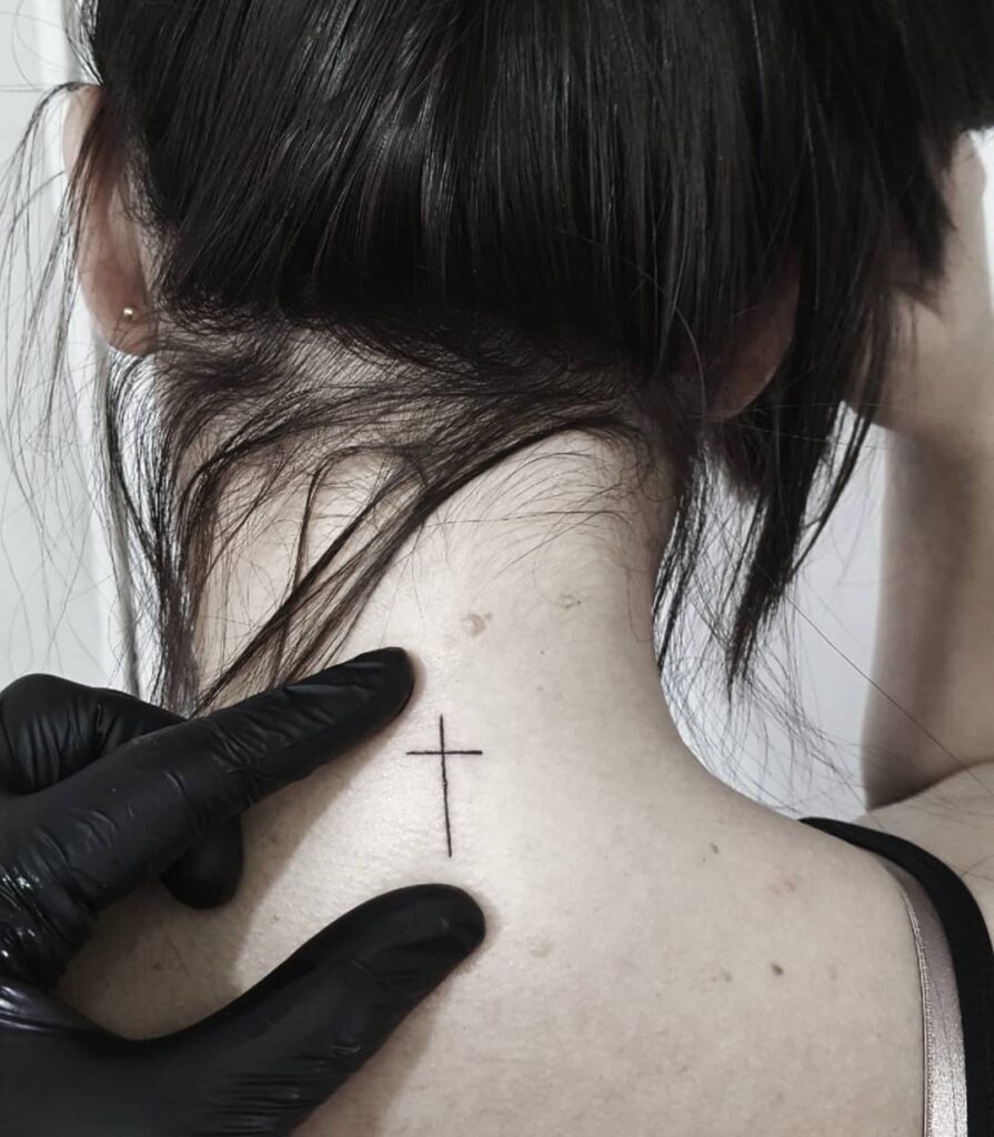 Girl back of the neck simple cross tattoo in red color thin