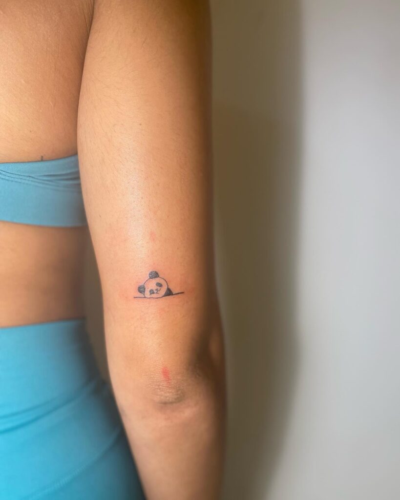 Girly cute panda tattoo design back of the above elbow