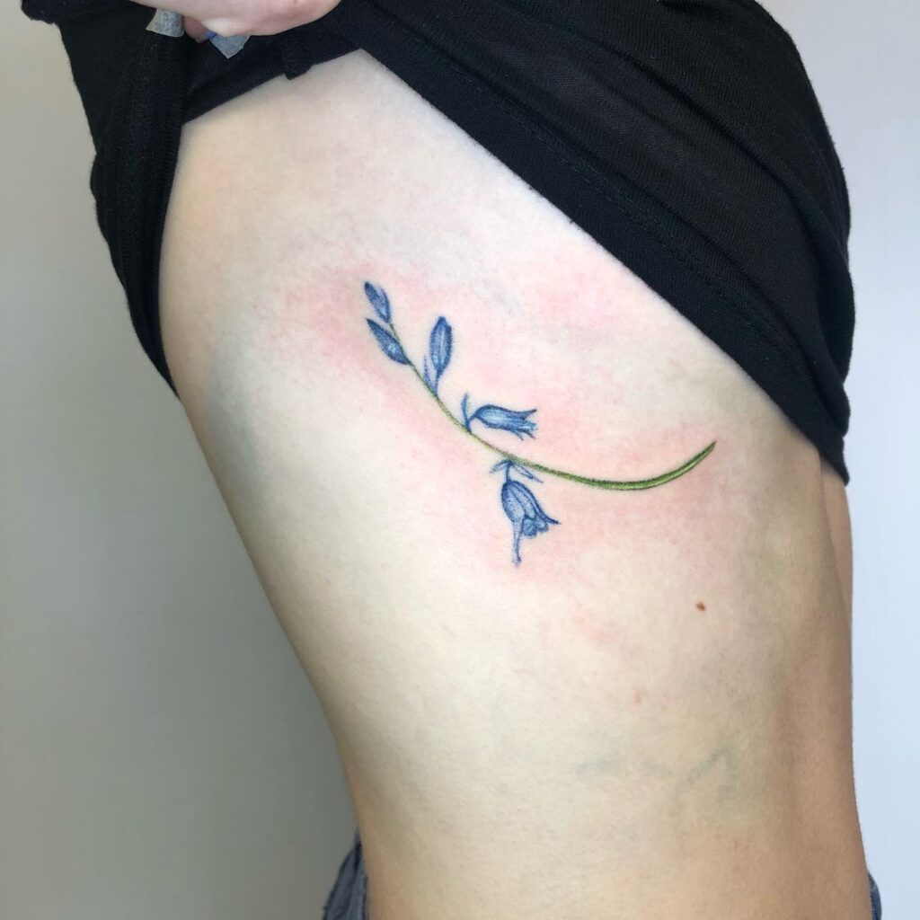 Graceful Bluebell Tattoo on the Rib for a Feminine Flourish: Ribbons of Nature