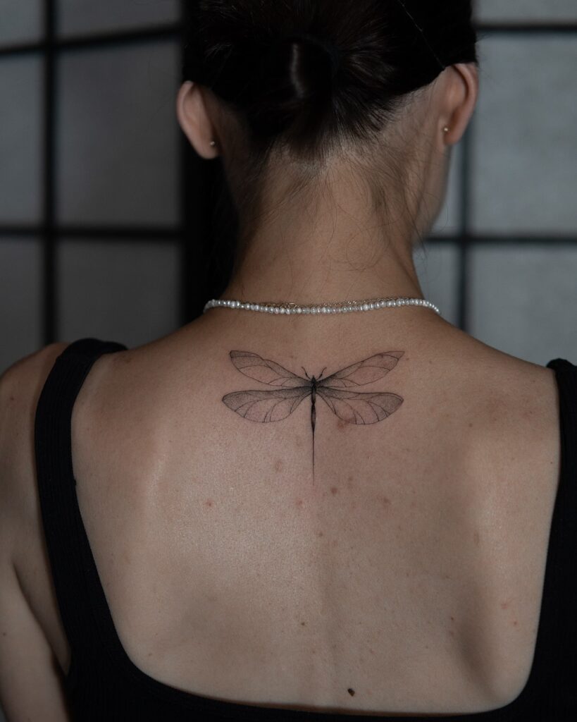 Graceful Upper Back Dragonfly Tattoo with Soft Shading for a Mystical Look
