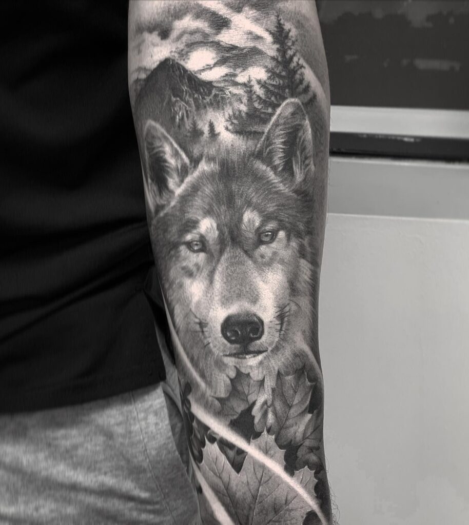 Grey color mountain and wolf theme inner forearm tattoo natural harmony