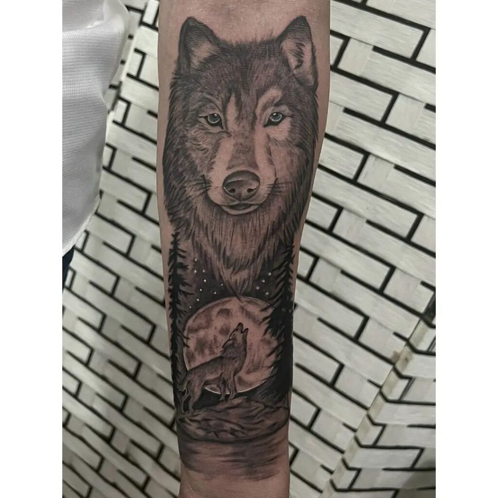 Grey color wolf howling at the moon forearm tattoo nocturnal serenade