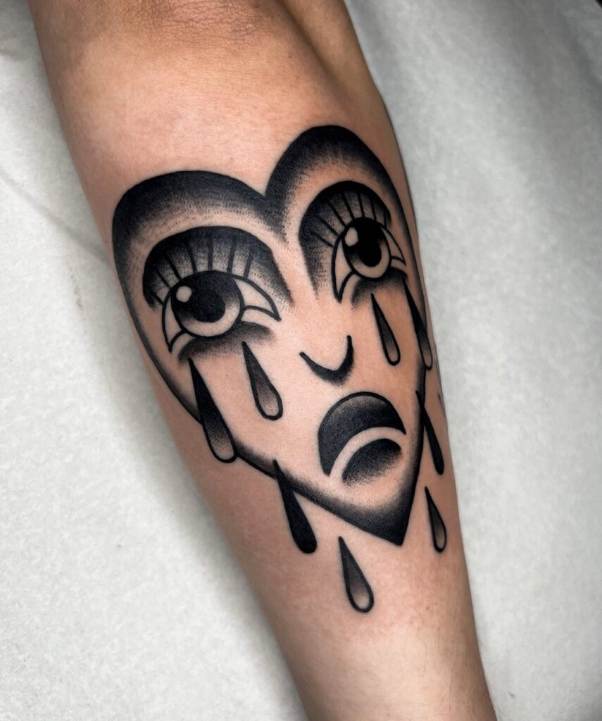 Grimm crying heart outer forearm blackwork tattoo