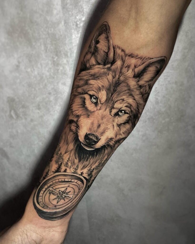 Guided by instinct the lone wolf with compass forearm tattoo