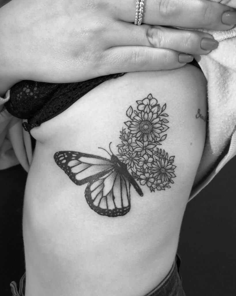 Half butterfly half sunflower tattoo on the rib for female: nature-inspired rib ink