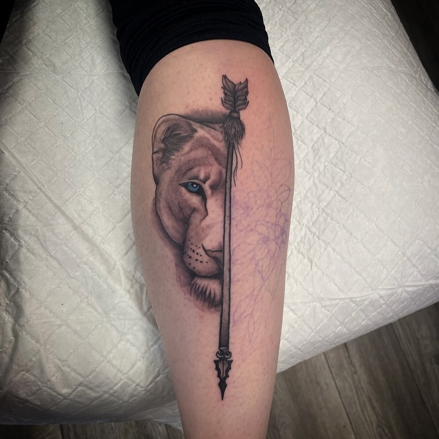 Half Lioness and Arrow Tattoo on the Calf - Black and Grey Shaded Elegance: Lioness Arrow Fusion 