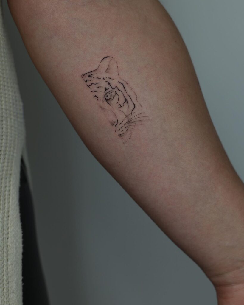 Half Tiger Face Tattoo on the Forearm, a Delicately Detailed Outline Design: Tiger Tale