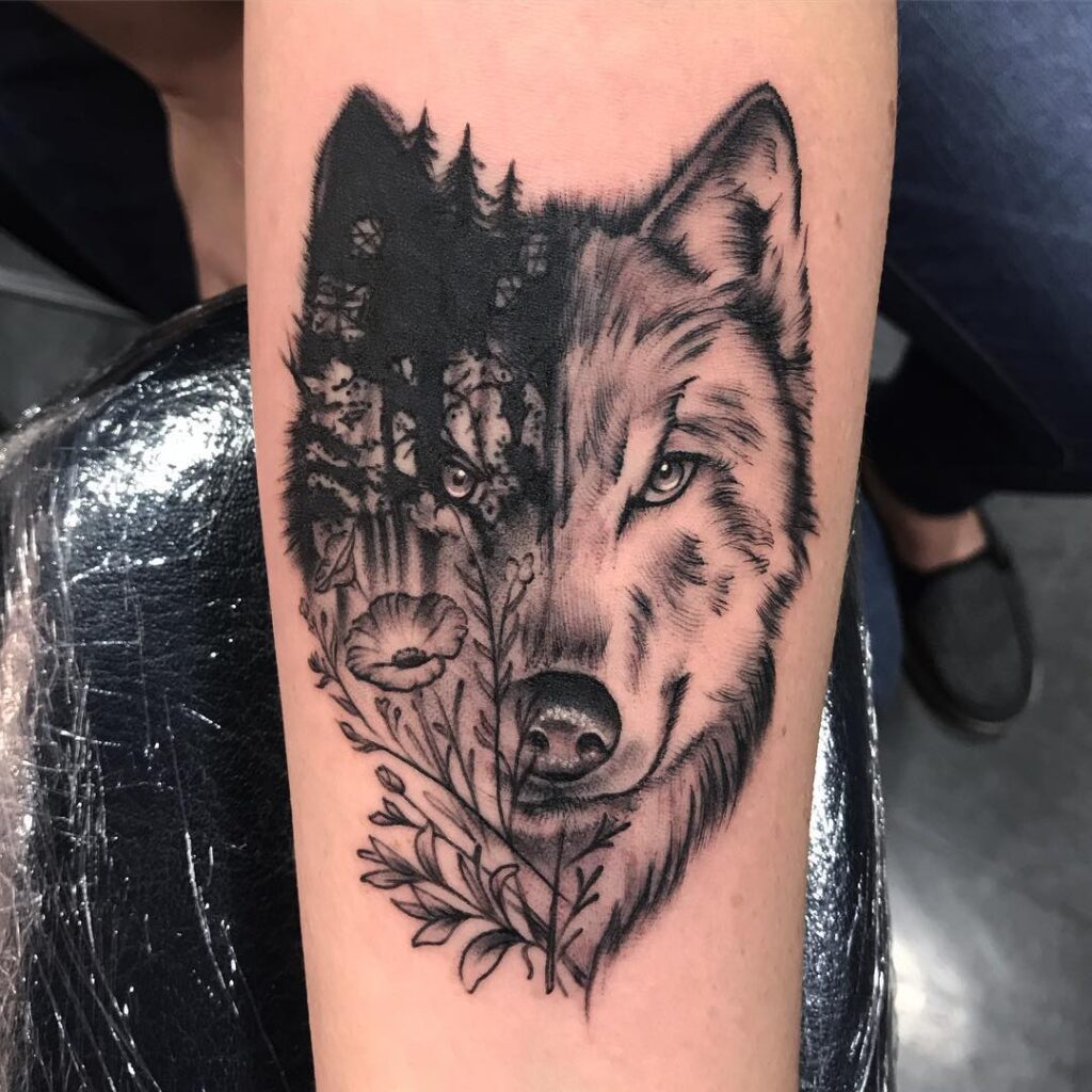 Half wolf and half forest wolf face tattoo forearm dual nature