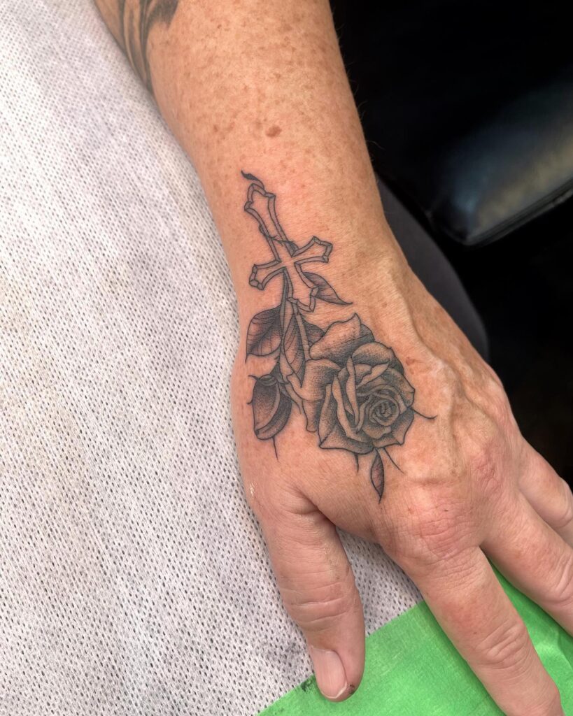 Hand cross with roses tattoo designs for men unique symbolism