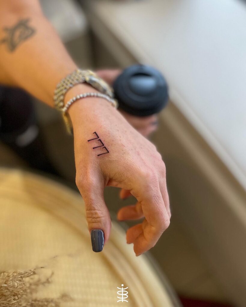Hand Tattoo for Women Featuring the Mystical Number: 777 Elegance 