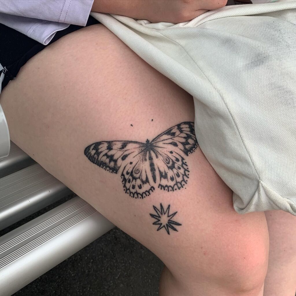 Healed beauty butterfly tattoo on the thigh